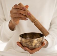 Close-Up Shot of a Person Using a Singing Bowl
